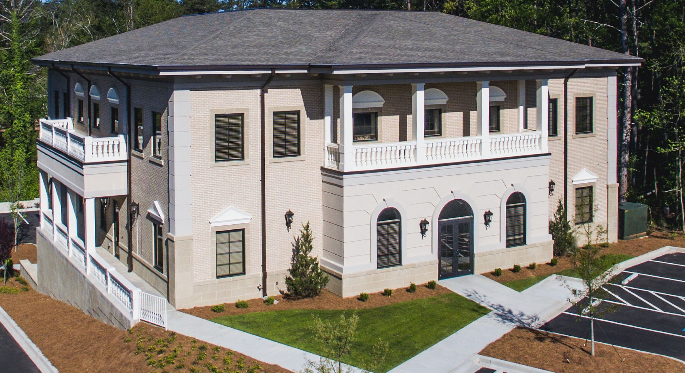 Elegant two-story building with landscaped surroundings.