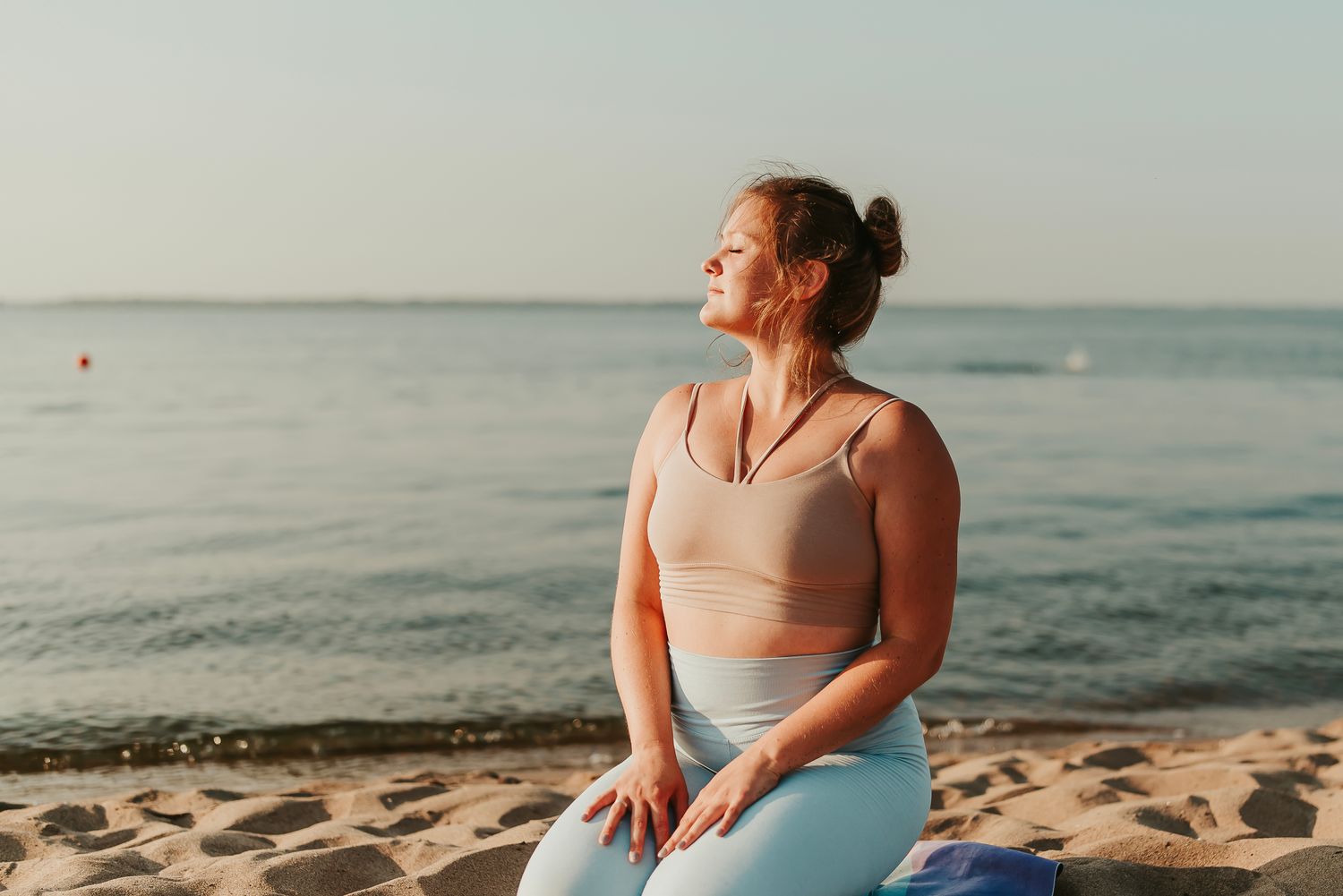 Alpharetta Urinary Incontinence Treatment model practicing mindfulness by the beach.